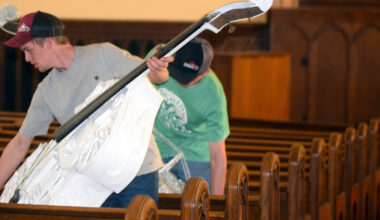 A bass violin is placed gingerly on a cushioned pew at the former Grace United Methodist Church while waiting for a room at The Esprit de Corps Academy.