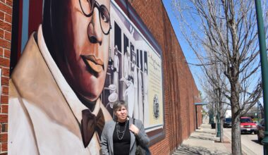 Judy Tighe stands in front of the mural Dr. Alonzo H. Kenniebrew on the side of the Lincoln Land Community College building on North Main Street, just off the downtown square. A new mural will be added to downtown's collection in coming months.