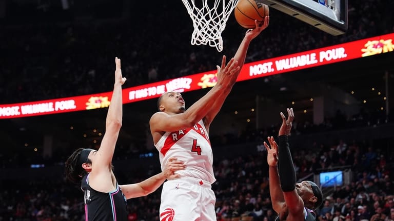 Toronto Raptors' Scottie Barnes (4) scores between Miami Heat's Jaime...
