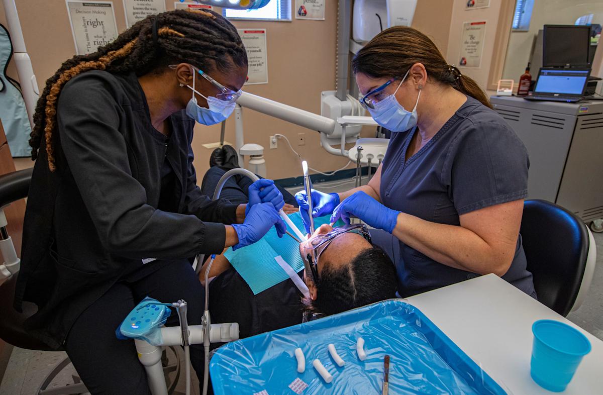 From left, Stephanie Vilfort, a student in the dental assisting program at Cape Coral Technical College practices cleaning skills on classmate Grace Provenzano under the guidance of instructor Chris Weygant Wednesday morning, March 16, 2022. Cape Coral Technical College is planning to expand its curriculum in an effort to bring more blue collar programs to the school.