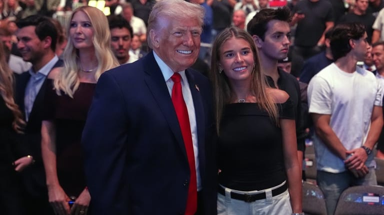 President Donald Trump stands with Kai Trump at the UFC...