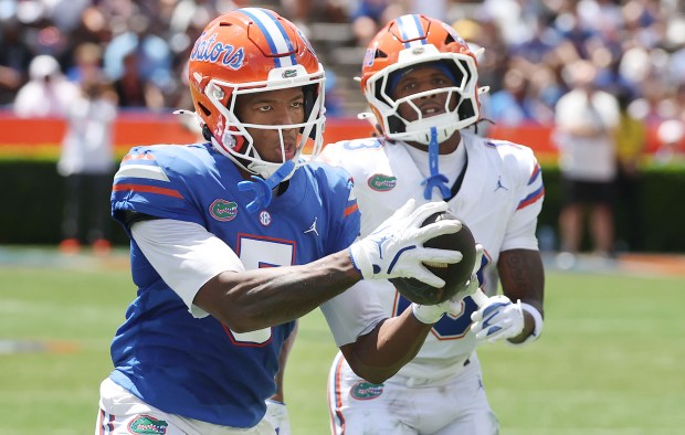 University of Florida receiver Micah Mays Jr. (5) concentrates to pull in a touchdown catch in front of cornerback Jordy Lowery (13) during the 2026 Orange & Blue Game Saturday at Ben Hill Griffin Stadium on the UF campus in Gainesville. (Stephen M. Dowell/Orlando Sentinel)