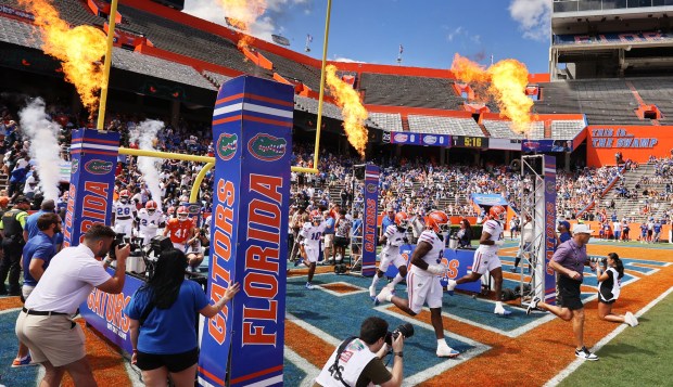 Florida head coach Jon Sumrall (right) leads his Gators onto the field for the 2026 Orange & Blue Game at Ben Hill Griffin Stadium on the UF campus. (Stephen M. Dowell/Orlando Sentinel)