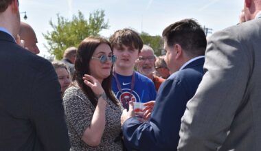 Jacksonville Alderwoman Eren White-Williams speaks with Gov. JB Pritzker during his visit to the city. White-Williams resigned from her position April 7.