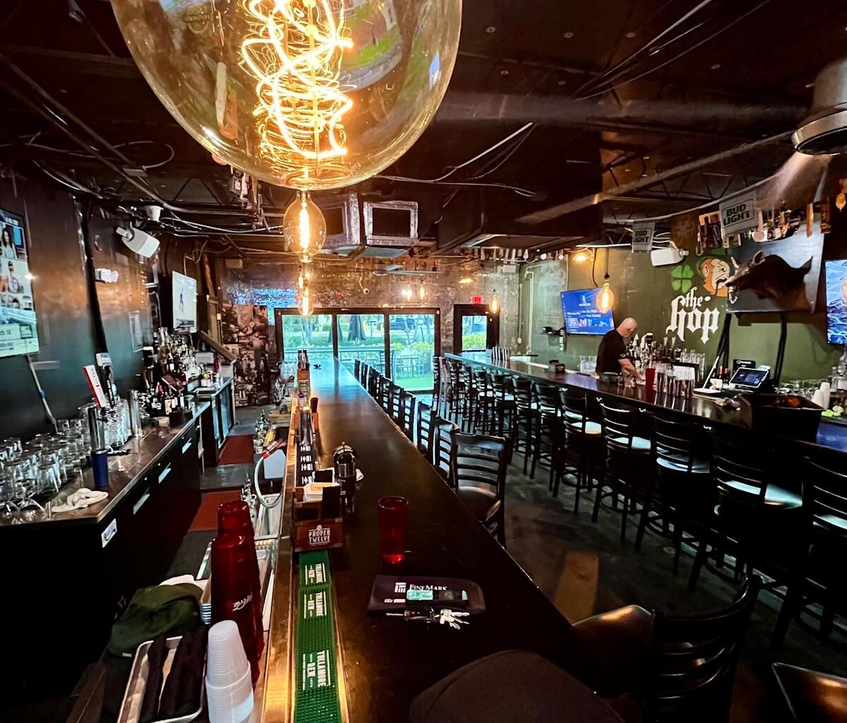 A partner at Cape Coral's long-time, beloved Nevermind Awesome Bar &amp; Eatery faces charges unrelated to the restaurant involving prostitution and racqueteering. Seen here in this file photo, the restaurant has two long Boston-style bars in Cape Coral
