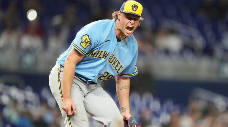 Milwaukee Brewers pitcher Trevor Megill reacts after getting the final...