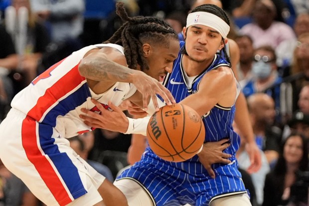 Magic guard Anthony Black, right, attempts to steal the ball from Pistons guard Daniss Jenkins during the second half of Monday's game at Kia Center. (AP Photo/John Raoux)