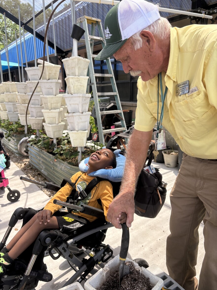 Buckingham Exceptional Center students enjoy their outdoor garden and receive help maintaining it from a volunteer. The garden may not have a place at Royal Palm School if the schools merge.