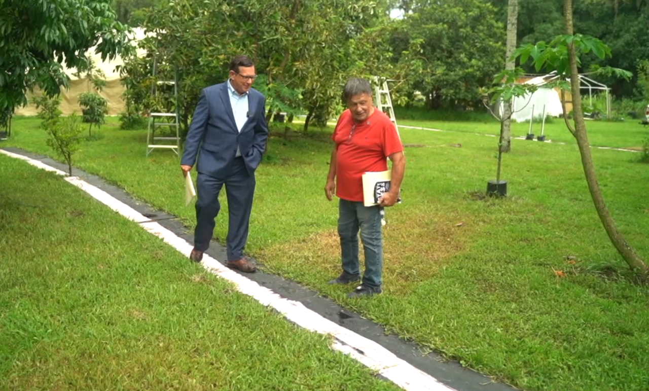 Hamid Salahutdin shows Adam Walser where he has marked the easement going through his property with shingles and pink paint