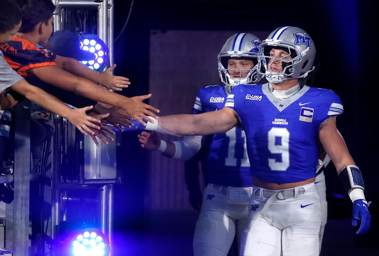 Middle Tennessee linebacker Parker Hughes (9), and Middle Tennessee quarterback Nicholas Vattiato (11) greet players as they take to the field for the coin toss before the start of the football game between Middle Tennessee and Missouri State on Wednesday, October 8, 2025, at MTSU.