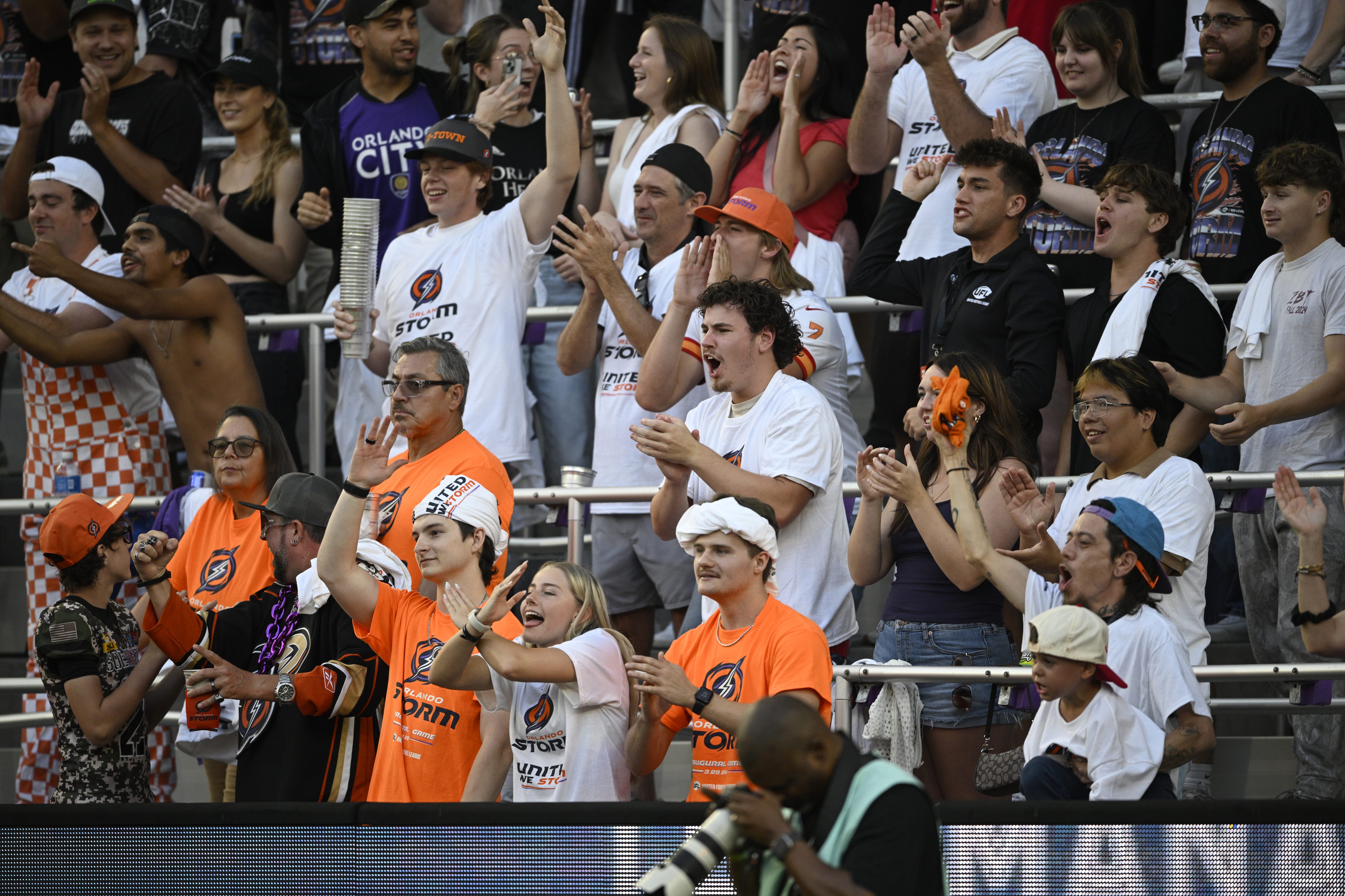 Fans cheer in the stands during a UFL football game...