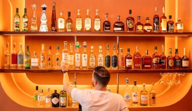 Bartender getting a drink in front of an orange bar