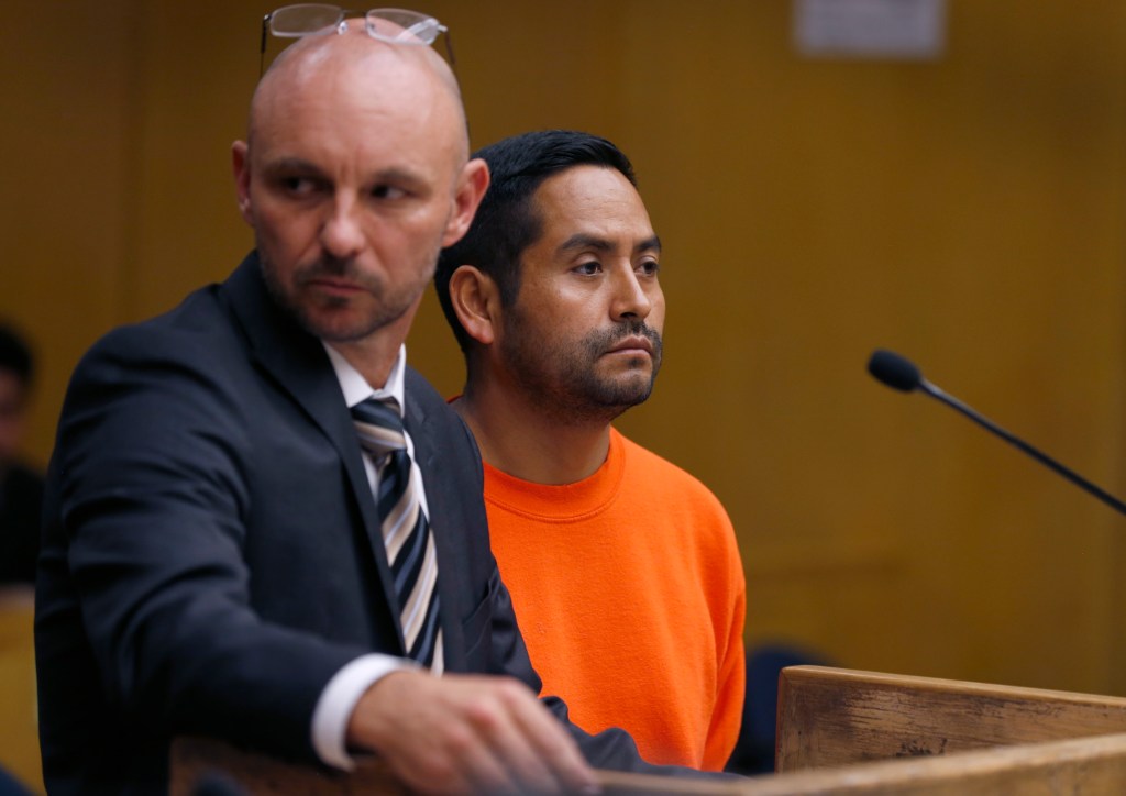 Orlando Vilchez Lazo is seen in court in an orange jump suit.