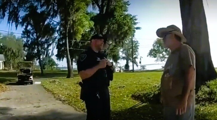 Former Orange Park Mayor Eugene Nix, right, denied to a pair of OPPD officers taking a Town Council campaign sigh for Doug Benefield. After being told he was seen taking it on home surveillance, Nix confessed to taking it and throwing it away.