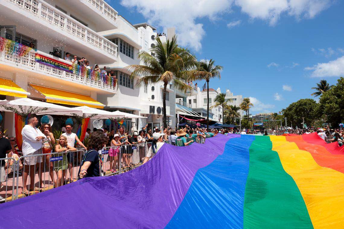 A rainbow flag is carried down Ocean Drive during the 18th annual pride parade in Miami Beach, Florida, Sunday, April 12, 2026.