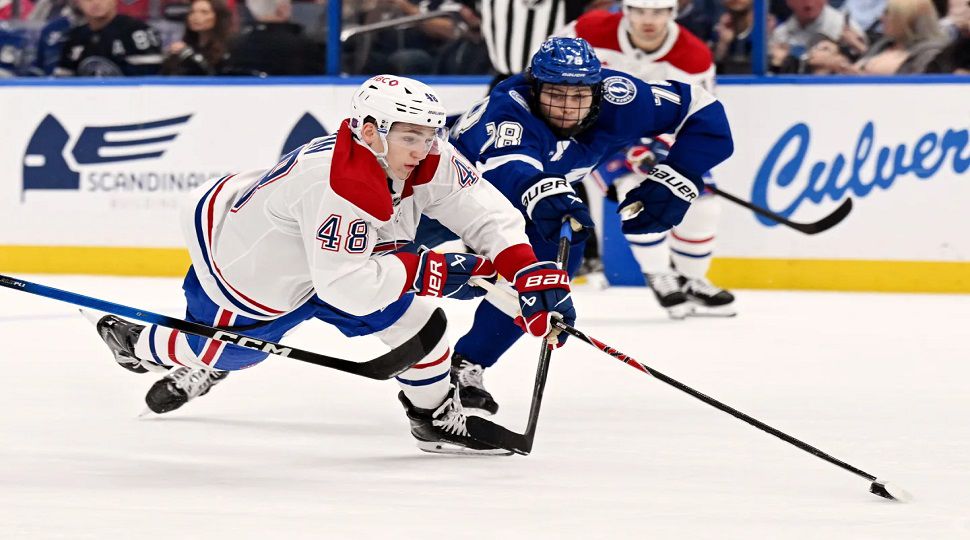 Montréal Canadiens defenseman Lane Hutson (48) is tripped up as Tampa Bay Lightning defenseman Emil Lilleberg (78) defends during the first period of an NHL hockey game, Tuesday, March 31, 2026, in Tampa, Fla. (AP Photo/Jason Behnken)