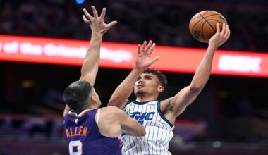 Phoenix Suns forward Royce O'Neale (00) goes up to shoot as Orlando Magic forward Jamal Cain (8) defends during the first half of an NBA basketball game, Tuesday, March 31, 2026, in Orlando, Fla. (AP Photo/Phelan M. Ebenhack)
