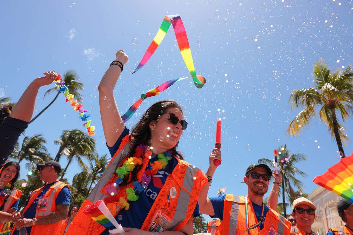 A supporter of the LGBTQ community representing American Airlines walk down Ocean Drive during the 18th annual pride parade in Miami Beach, Florida, Sunday, April 12, 2026.