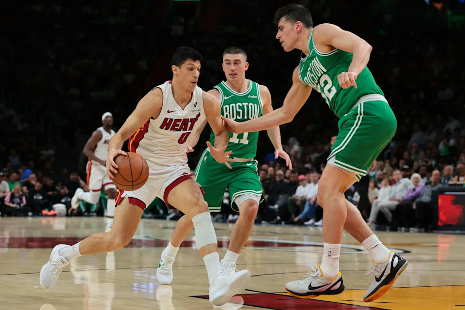 Apr 1, 2026; Miami, Florida, USA; Miami Heat forward Simone Fontecchio (0) drives to the basket against Boston Celtics center Luka Garza (52) during the second quarter at Kaseya Center. Mandatory Credit: Sam Navarro-Imagn Images