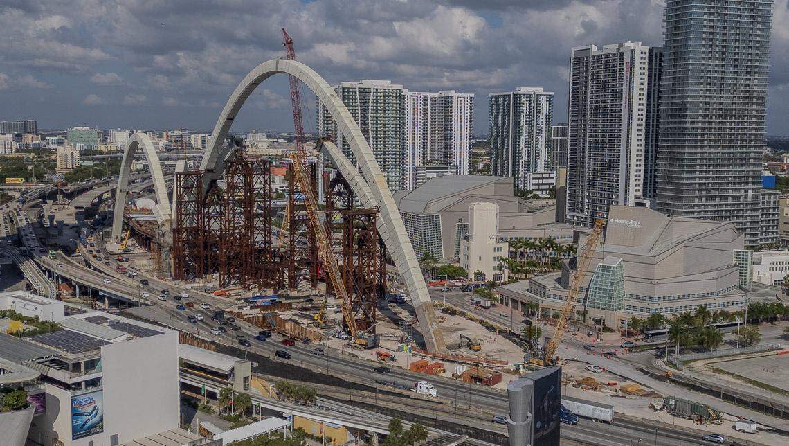 The arches for the Interstate 395 “signature bridge” over Biscayne Boulevard rise between the Arsht Center, to the right, and the Frost Science Museum, bottom left.