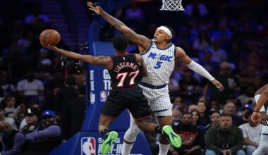 Philadelphia 76ers' VJ Edgecombe, left, goes up for a shot against Orlando Magic's Paolo Banchero during the first half of an NBA play-in tournament basketball game Wednesday, April 15, 2026, in Philadelphia. (AP Photo/Matt Slocum)