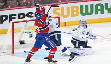 Montreal Canadiens' Kirby Dach (77) reacts to a goal by teammate Lane Hutson against Tampa Bay Lightning goaltender Andrei Vasilevskiy (88) during overtime in an NHL hockey playoff game in Montreal, Friday, April 24, 2026. (Graham Hughes/The Canadian Press via AP)