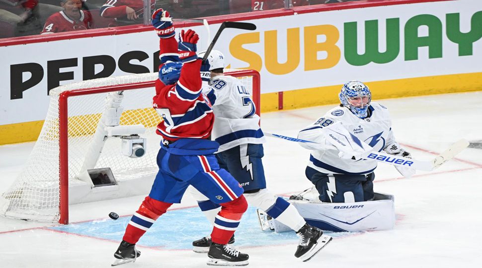 Montreal Canadiens' Kirby Dach (77) reacts to a goal by teammate Lane Hutson against Tampa Bay Lightning goaltender Andrei Vasilevskiy (88) during overtime in an NHL hockey playoff game in Montreal, Friday, April 24, 2026. (Graham Hughes/The Canadian Press via AP)