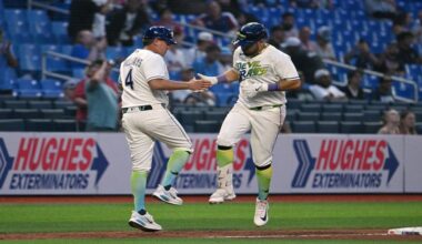 Tampa Bay Rays third base coach Brady Williams (4) and Jonathan Aranda, right, celebrate after Aranda's home run during the sixth inning of a baseball game against the Minnesota Twins, Friday, April 24, 2026, in St. Petersburg, Fla. (AP Photo/Jason Behnken)