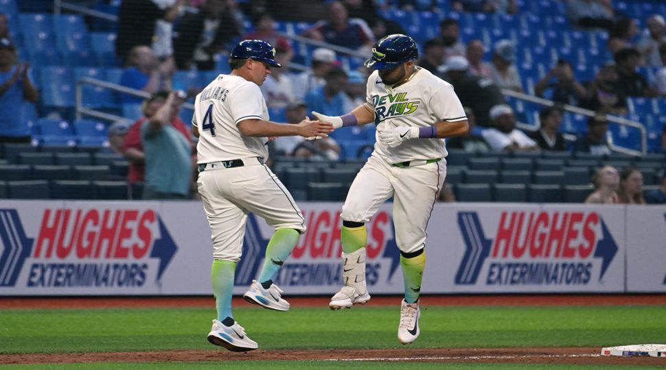Tampa Bay Rays third base coach Brady Williams (4) and Jonathan Aranda, right, celebrate after Aranda's home run during the sixth inning of a baseball game against the Minnesota Twins, Friday, April 24, 2026, in St. Petersburg, Fla. (AP Photo/Jason Behnken)