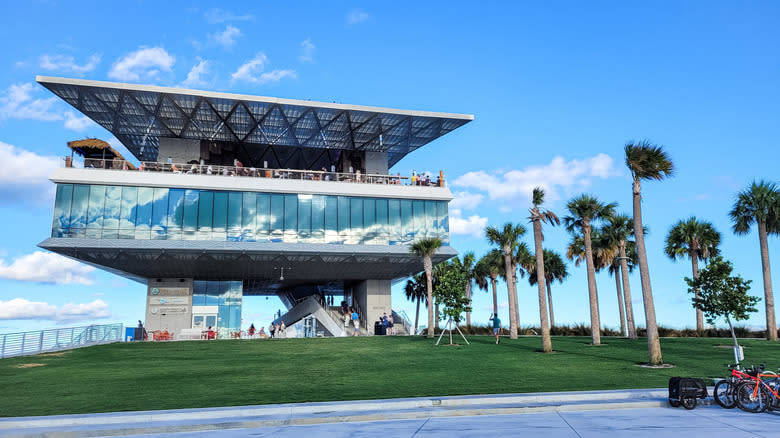 Square structure with restaurant terrace, amidst palm trees