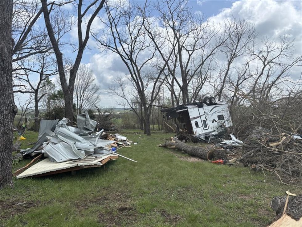 Utility crews and volunteers worked side by side Wednesday to help residents recover from...