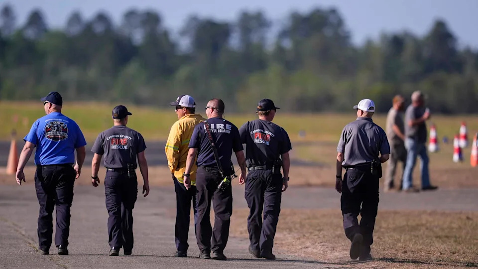Fire crews and truck assemble at the Brantley County Airport as they work the Brantley highway 82 fire, Thursday, April 23, 2026, near Nahunta, Ga. (AP Photo/Mike Stewart)