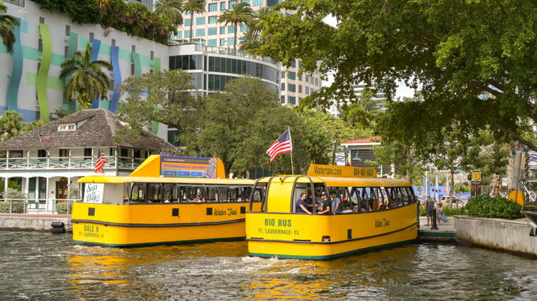 Two yellow Fort Lauderdale Water Taxis picking up passengers.