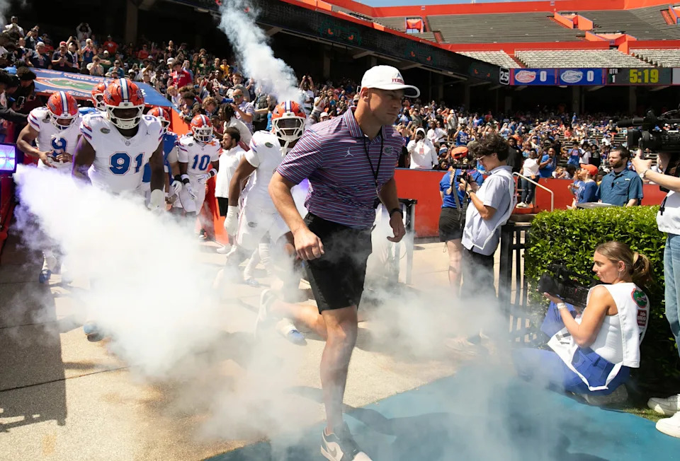 Florida head coach Jon Sumrall and the team blasts out onto the field before the Orange and Blue game at Steve Spurrier Field at Ben Hill Griffin Stadium in Gainesville, FL on Saturday, April 11, 2026. [Alan Youngblood/Gainesville Sun]