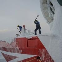 Crew members of the Sarfaq Ittuk ferry de-ice the bow with sledgehammers | News