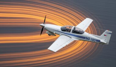 An abstract, blurred image of a Diamond DA40 NG aircraft in flight, with sweeping streaks of color conveying a sense of speed and modern engineering.