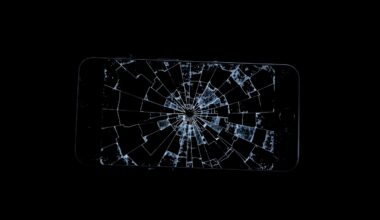 An extreme close-up photograph of a shattered cell phone screen, reflecting a faint glow against a dark background, conceptually representing the aftermath of a violent incident.