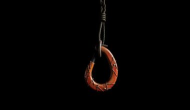 An extreme close-up of a twisted, damaged crane hook reflecting a harsh, direct camera flash, conceptually illustrating the aftermath of a construction accident.