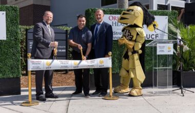 UCF President Alexander N. Cartwright (left) and Orlando Health Chief Physician Officer Jamal Hakim, M.D. (right) celebrate the opening of Orlando Health Strategic Innovations located on UCF's main campus.