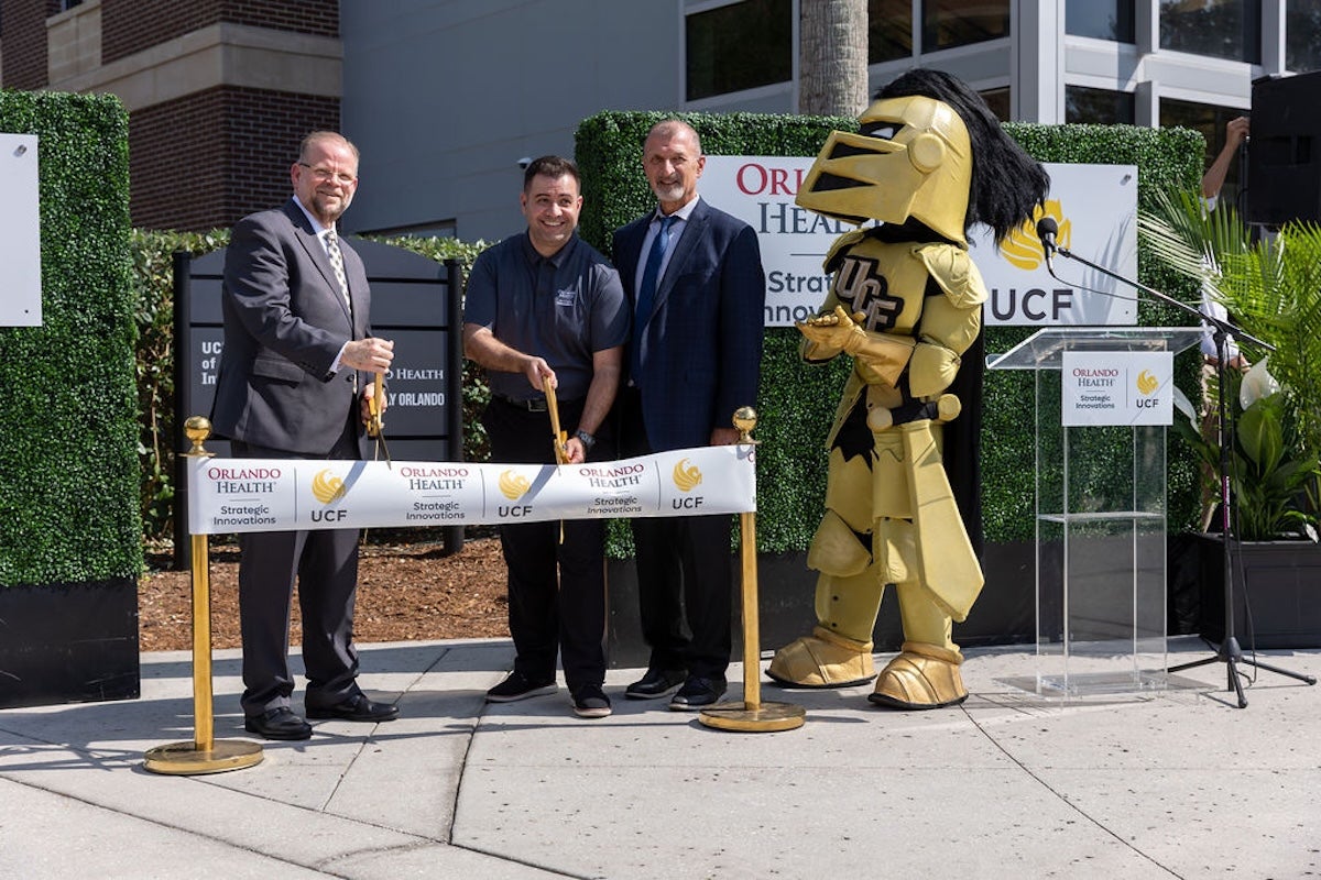 UCF President Alexander N. Cartwright (left) and Orlando Health Chief Physician Officer Jamal Hakim, M.D. (right) celebrate the opening of Orlando Health Strategic Innovations located on UCF's main campus.
