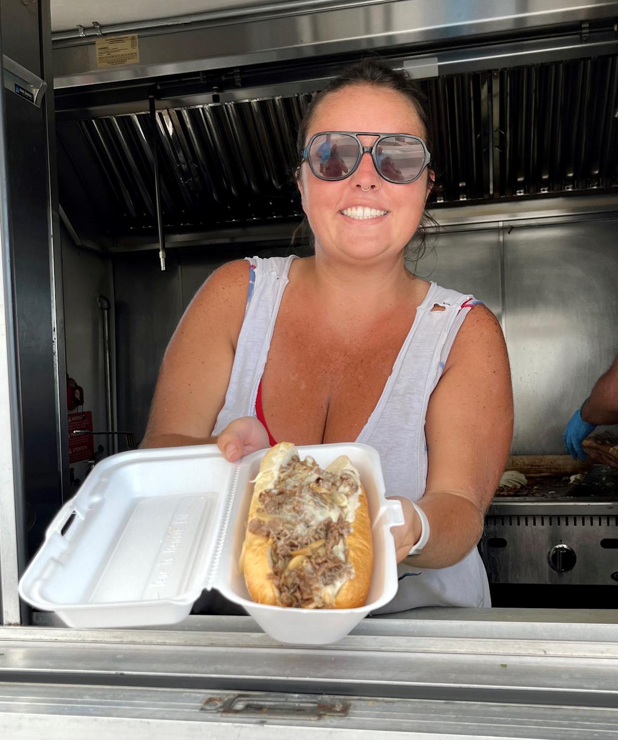 Double Dee's Munchies owner Gabby Ferraro serves up one of her popular cheesesteaks.