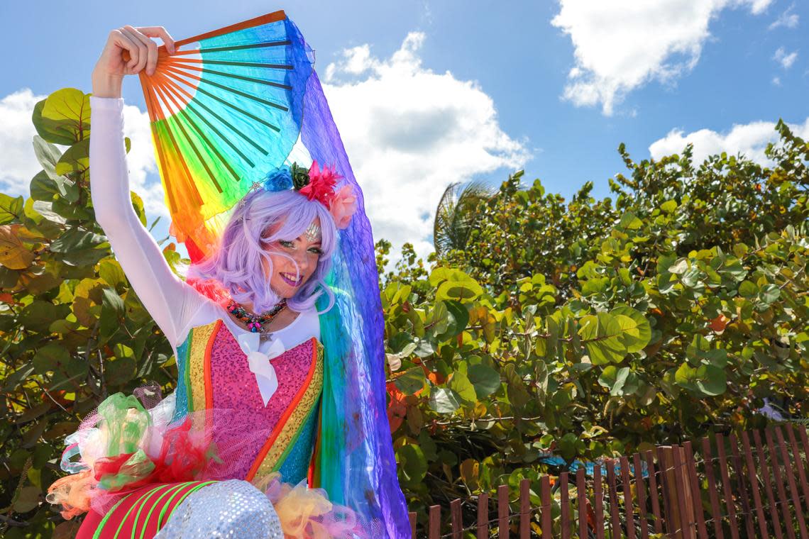 Mesodi Bergman poses for a photo before walking down Ocean Drive during the 18th annual pride parade in Miami Beach, Florida, Sunday, April 12, 2026.