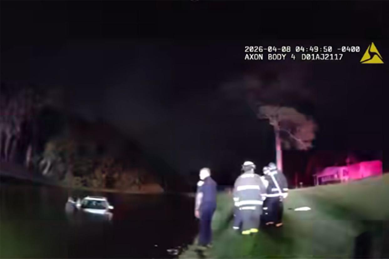 A screengrab from bodycam footage shared by Port St. Lucie Police of a rescue after a car submerged in a pond on April 8, 2026Credit: facebook