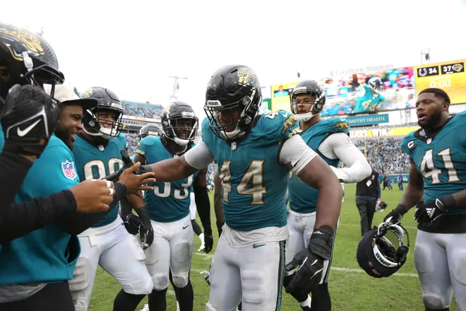 JACKSONVILLE, FLORIDA - OCTOBER 06: Travon Walker #44 of the Jacksonville Jaguars celebrates with teammates during the fourth quarter against the Indianapolis Colts at EverBank Stadium on October 06, 2024 in Jacksonville, Florida. (Photo by Courtney Culbreath/Getty Images)