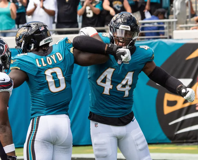 Jacksonville Jaguars defensive end Travon Walker (44) celebrates a sack Houston Texans quarterback CJ. Stroud (7) with teammate Jaguars linebacker Devin Lloyd (0) during the first quarter between the Houston Texans and the Jacksonville Jaguars Sunday September 21, 2025 at EverBank Stadium in Jacksonville, Fla. [Doug Engle/Florida Times-Union]