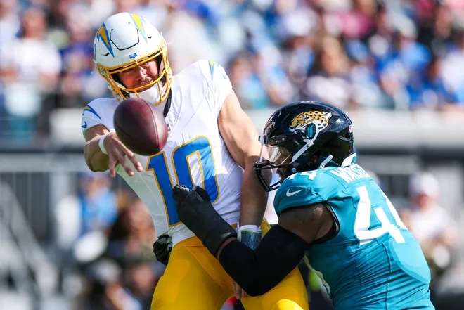Nov 16, 2025; Jacksonville, Florida, USA; Jacksonville Jaguars defensive end Travon Walker (44) pressures Los Angeles Chargers quarterback Justin Herbert (10) into an intentional grounding penalty during the first quarter at EverBank Stadium. Mandatory Credit: Nathan Ray Seebeck-Imagn Images