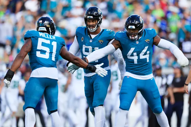 Jacksonville Jaguars linebacker Ventrell Miller (51) is high-fived by defensive end Travon Walker (44) as defensive tackle Arik Armstead (91) looks on during the fourth quarter of an NFL football matchup, Sunday, Oct. 12, 2025, at EverBank Stadium in Jacksonville, Fla. The Seahawks defeated the Jaguars 20-12.