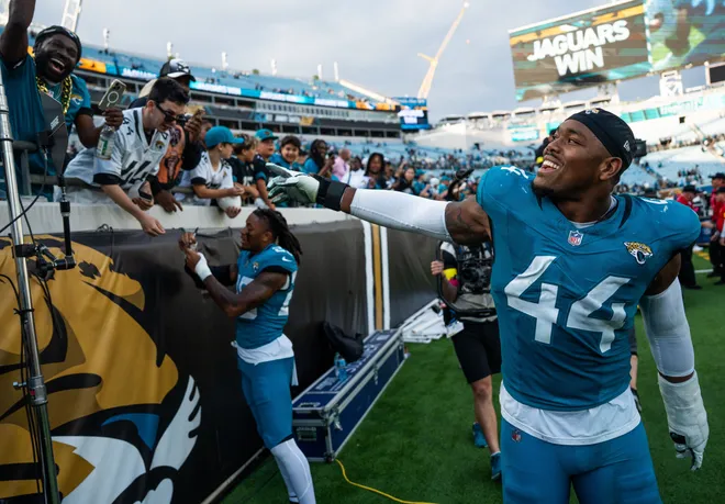Jacksonville Jaguars defensive end Travon Walker (44) celebrates with fans at EverBank Stadium, Sunday, Dec. 14, 2025, in Jacksonville, Fla. The Jaguars defeated the Jets 48-20. [Doug Engle/Florida Times-Union]