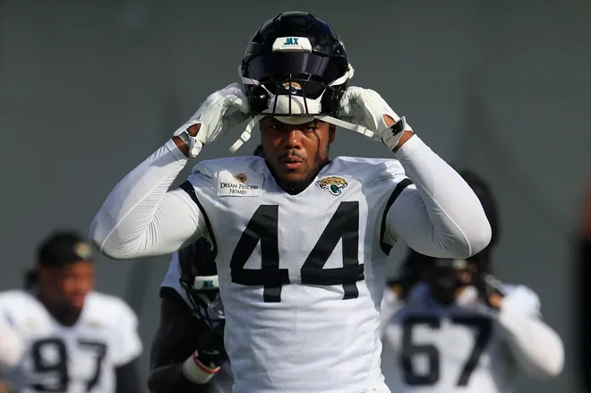 Jacksonville Jaguars defensive end Travon Walker (44) puts on his helmet during an NFL training camp session at the Miller Electric Center, Friday, July 25, 2025, in Jacksonville, Fla. [Corey Perrine/Florida Times-Union]
