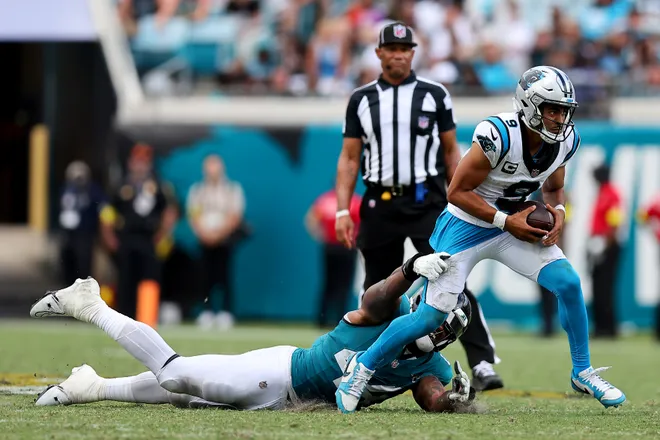 JACKSONVILLE, FLORIDA - SEPTEMBER 07: Travon Walker #44 of the Jacksonville Jaguars attempts to tackle Bryce Young #9 of the Carolina Panthers during the game at EverBank Stadium on September 07, 2025 in Jacksonville, Florida. (Photo by Mike Carlson/Getty Images)
